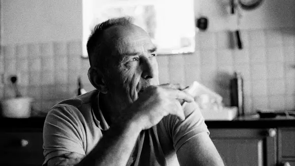 A man sitting at a table in a kitchen