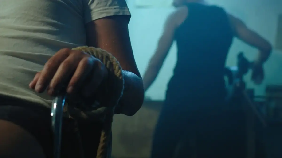 man in black t-shirt holding brown and black snake