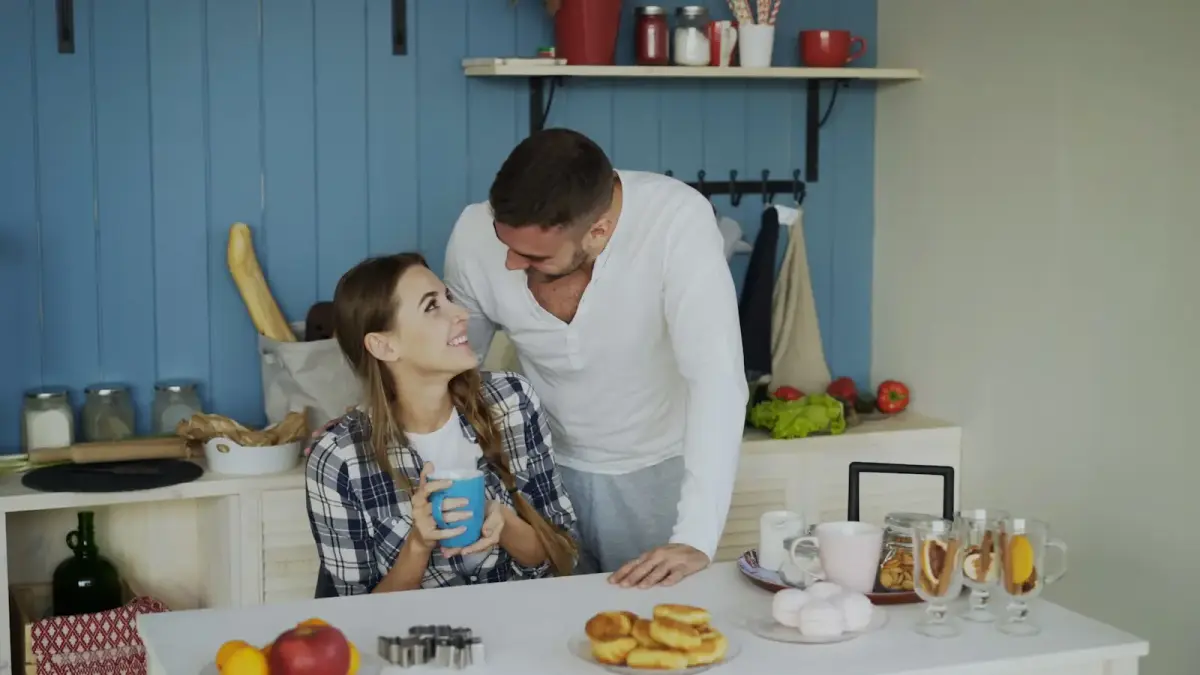 Couple sharing a morning moment in the kitchen.