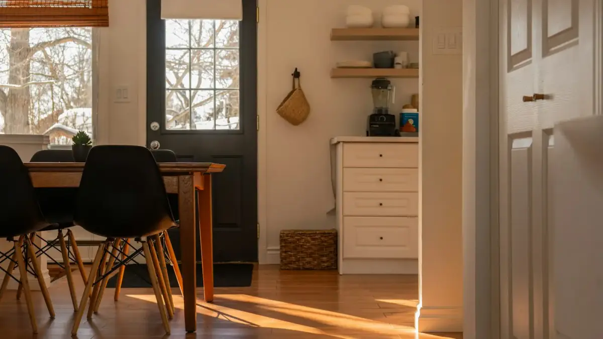 Sunlight streams into a cozy dining area and kitchen.