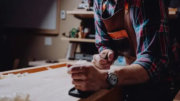 a man working on a piece of wood
