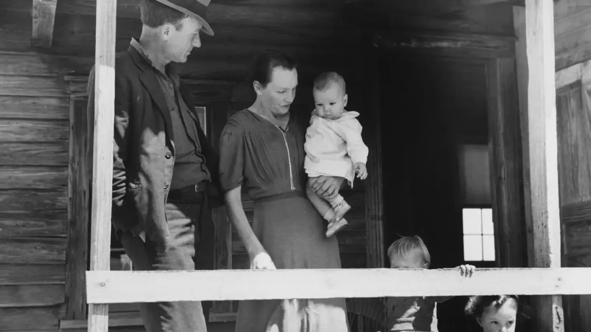 Family on a porch with children looking up.