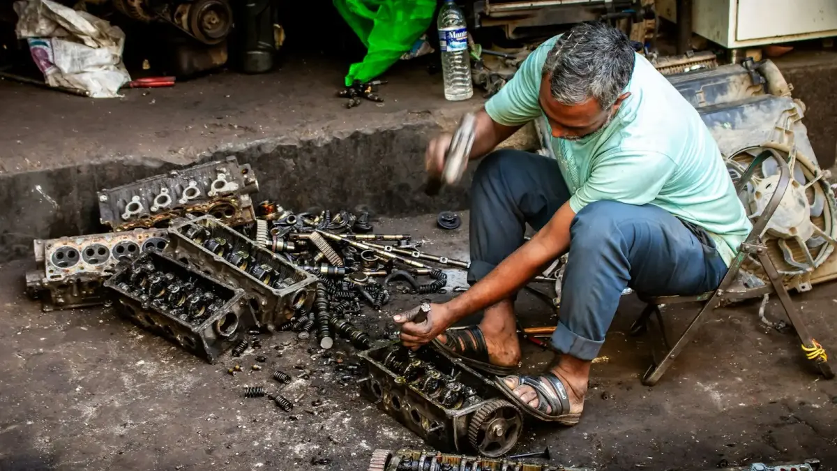 Mechanic working on car engine parts