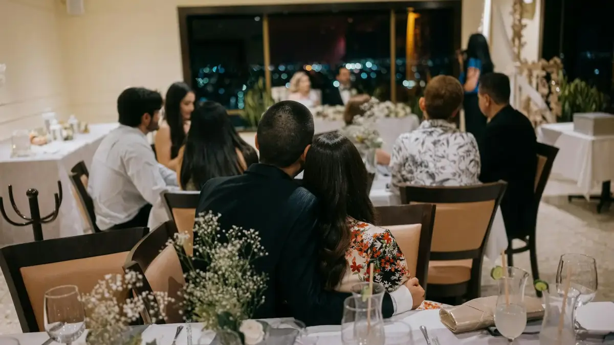 Wedding guests seated at decorated tables at night