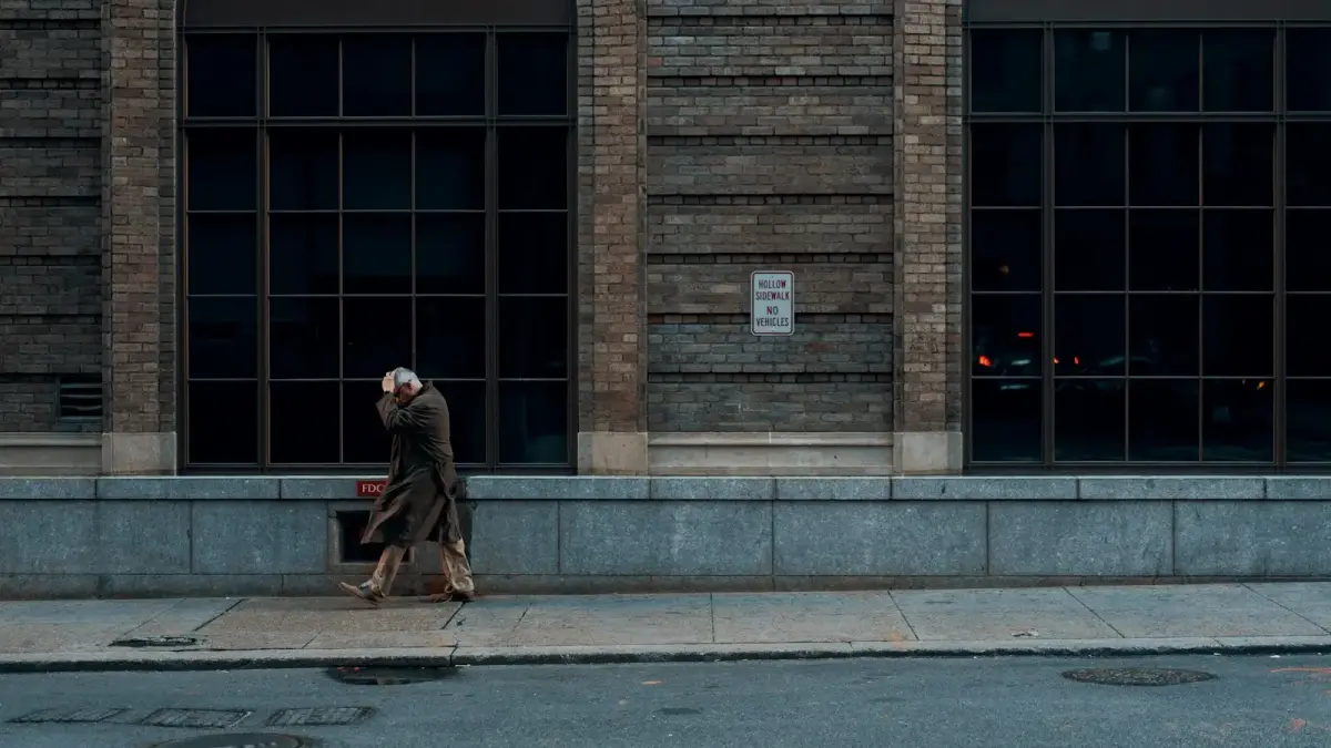 person standing beside building during daytime