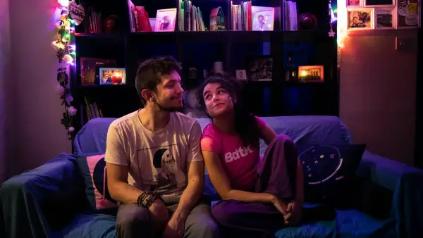 man in white crew neck t-shirt sitting beside woman in gray crew neck t-shirt