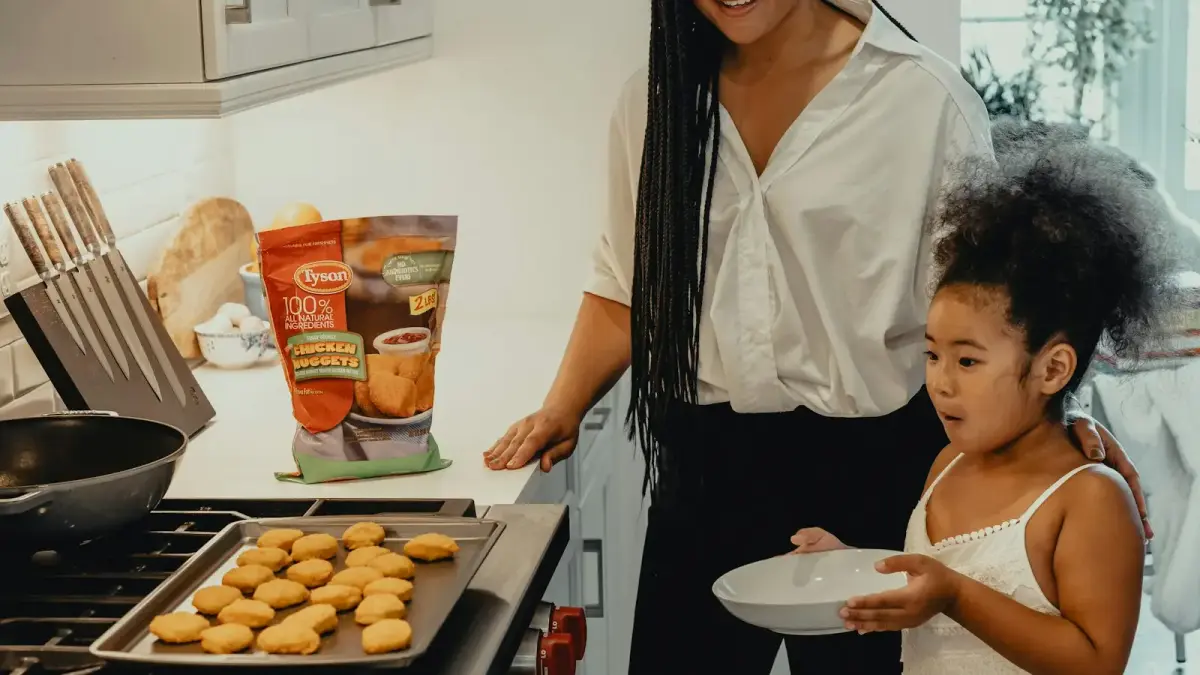 woman in white dress holding white ceramic plate with burger
