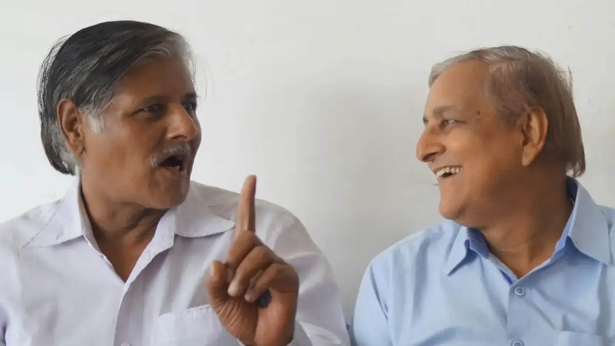 a person pointing at another man