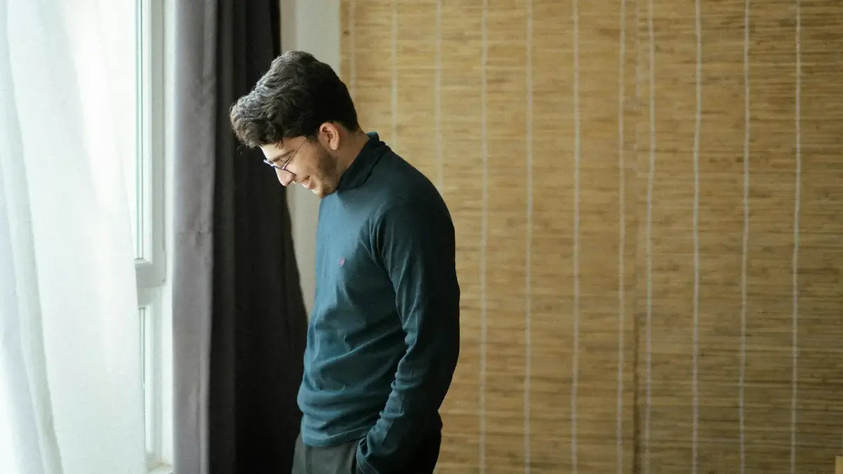 a man standing in front of a window