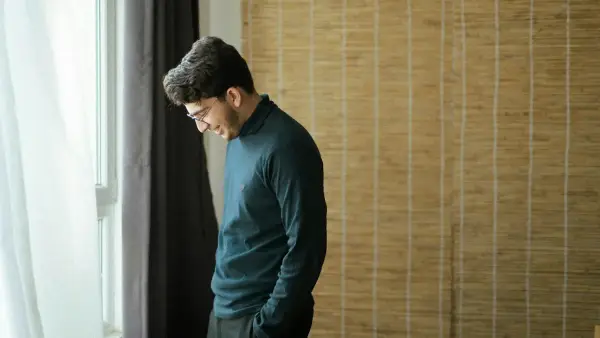 a man standing in front of a window