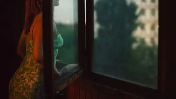 woman leaning on window