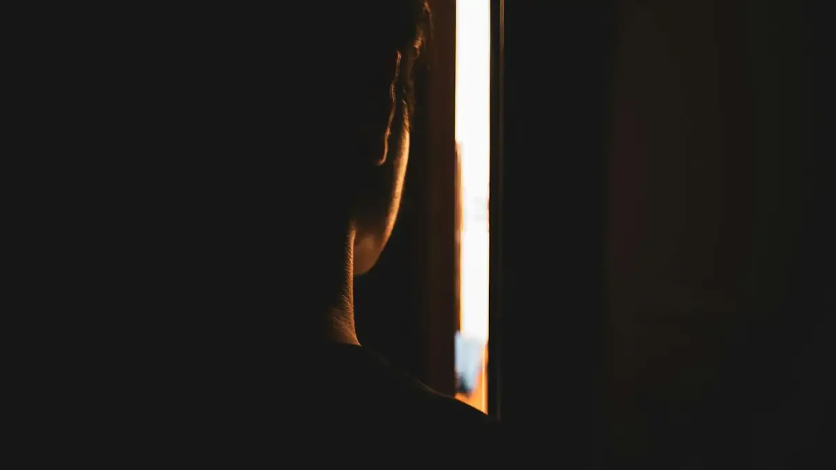 person looking throughh crack on door