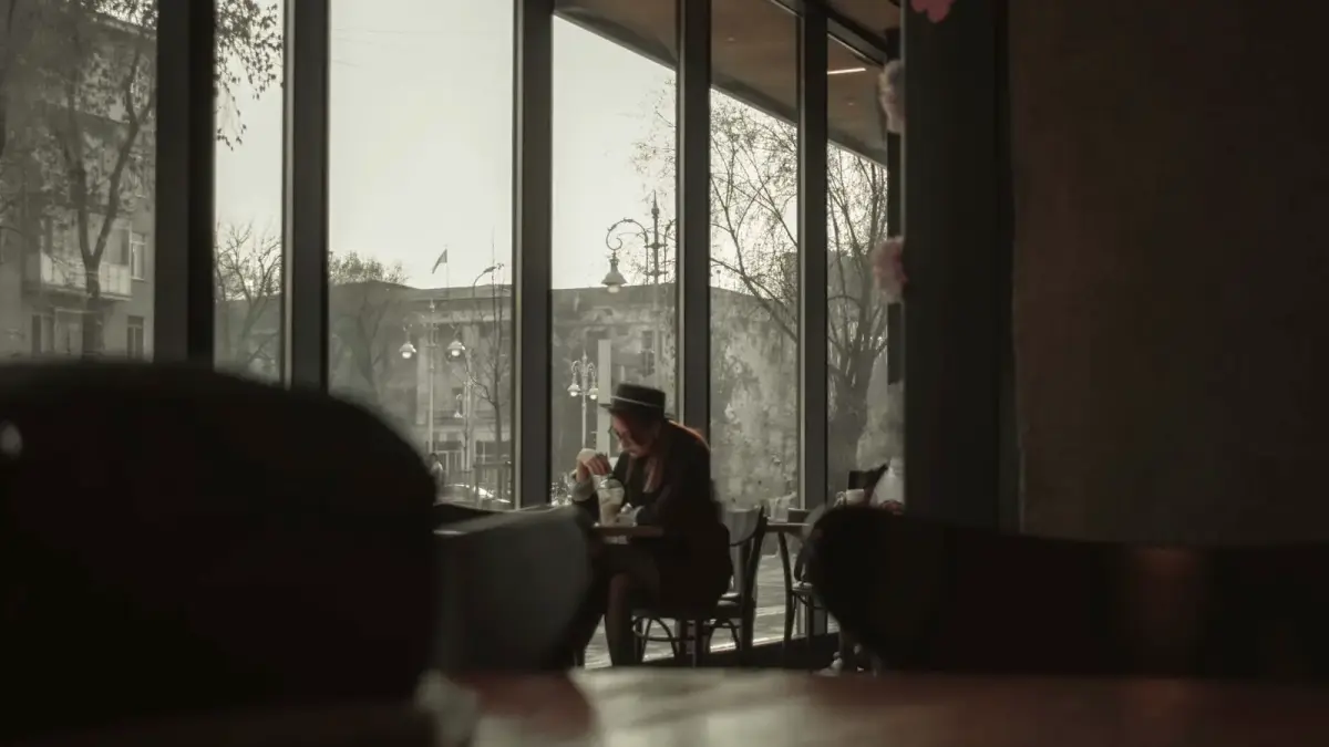 people sitting on chairs near window during daytime