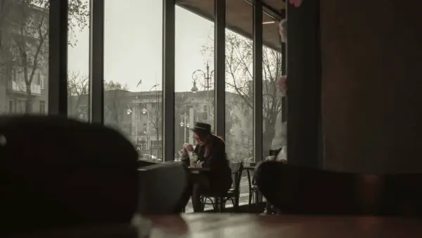 people sitting on chairs near window during daytime