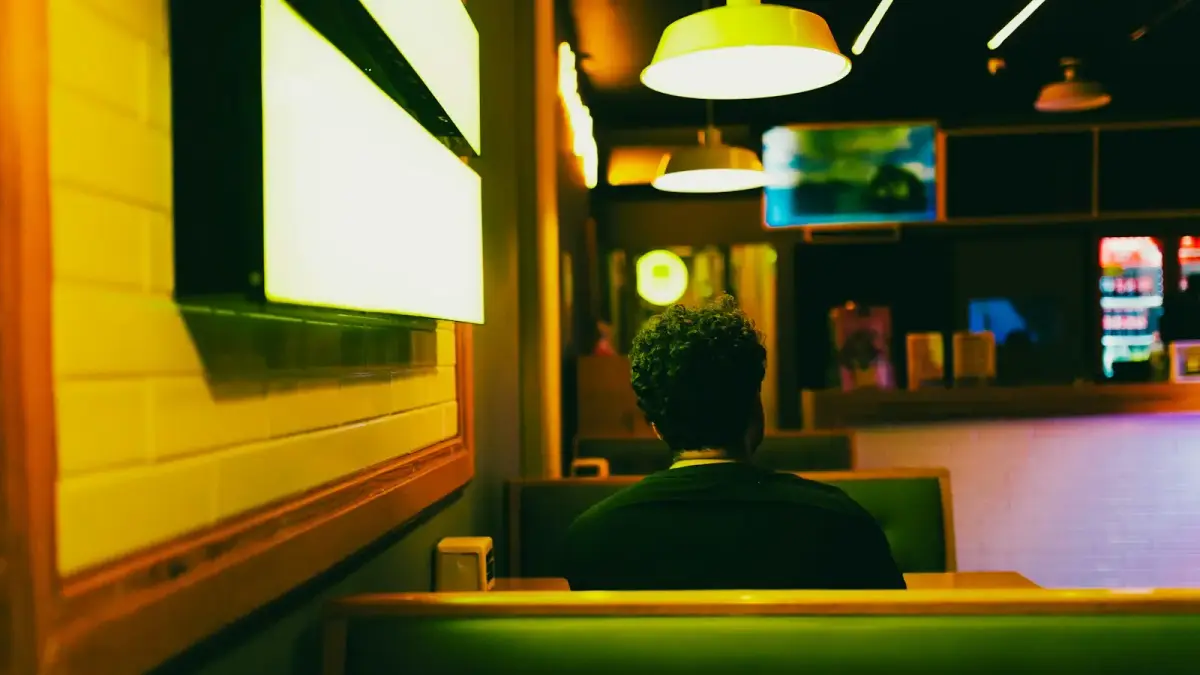 Man sitting in a booth at a restaurant