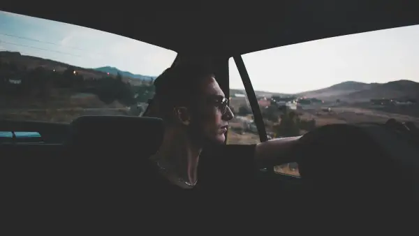 man in black shirt inside vehicle