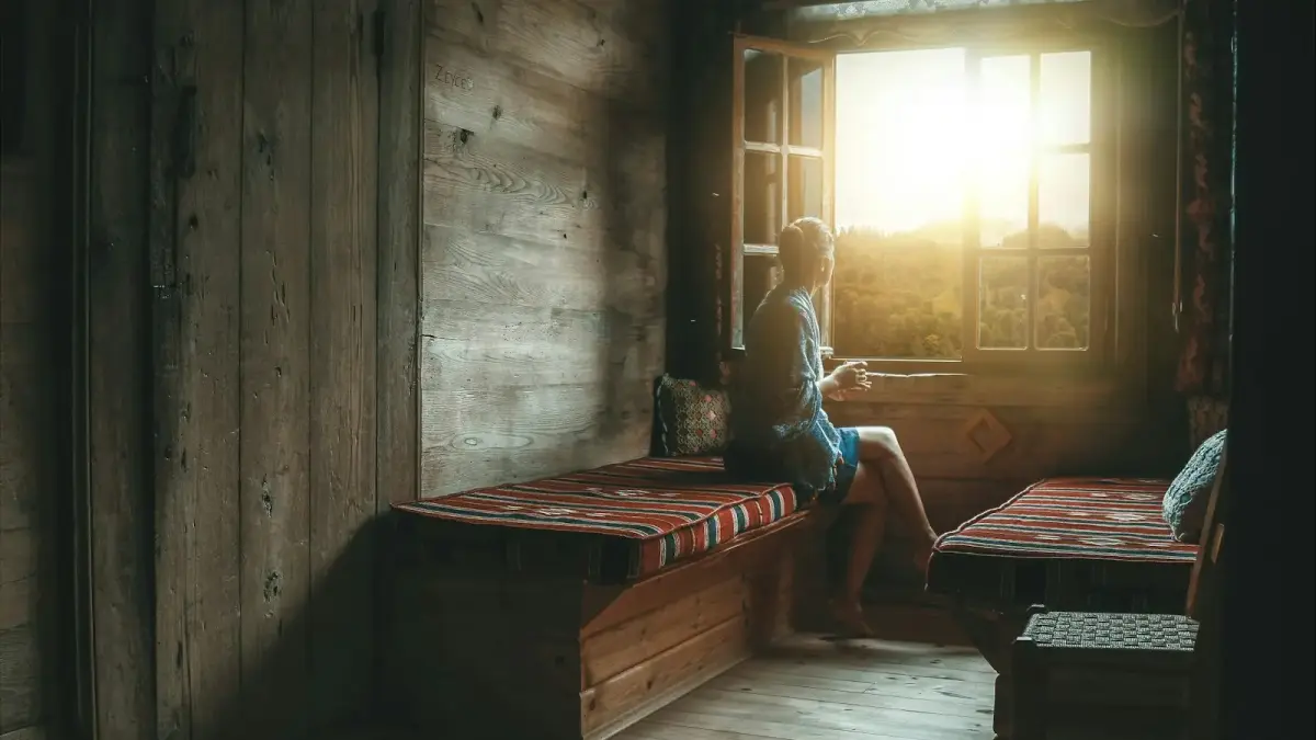 woman sitting beside window