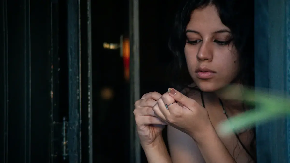 a woman is looking out of a window