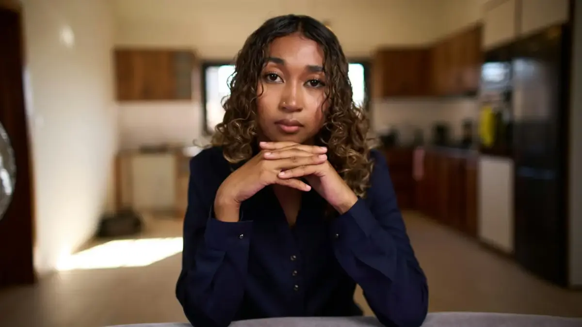 Young woman with curly hair looking at camera