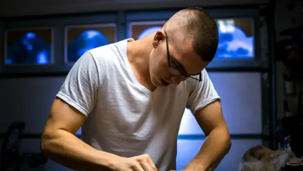 man in eyeglasses working inside room