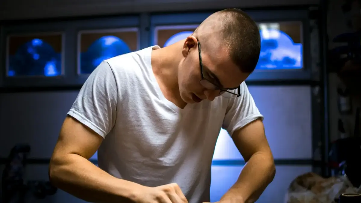 man in eyeglasses working inside room