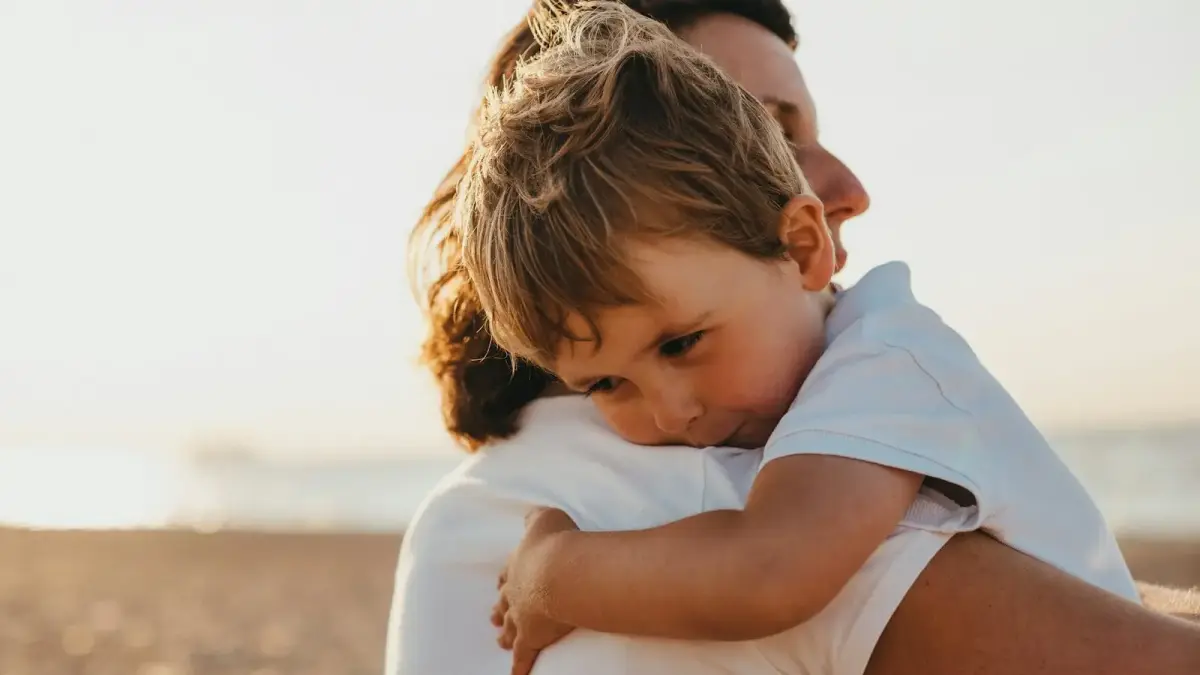 boy hugging woman during daytime