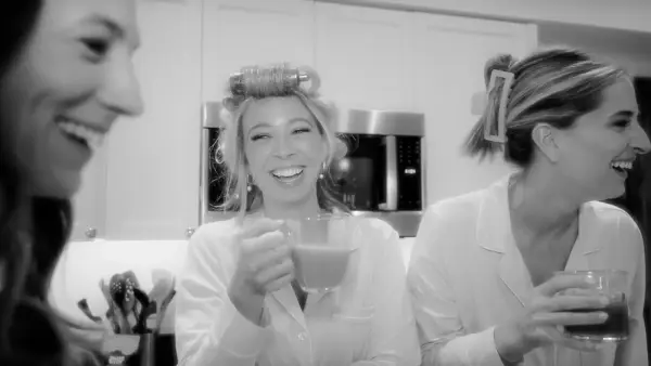 a group of women standing next to each other in a kitchen