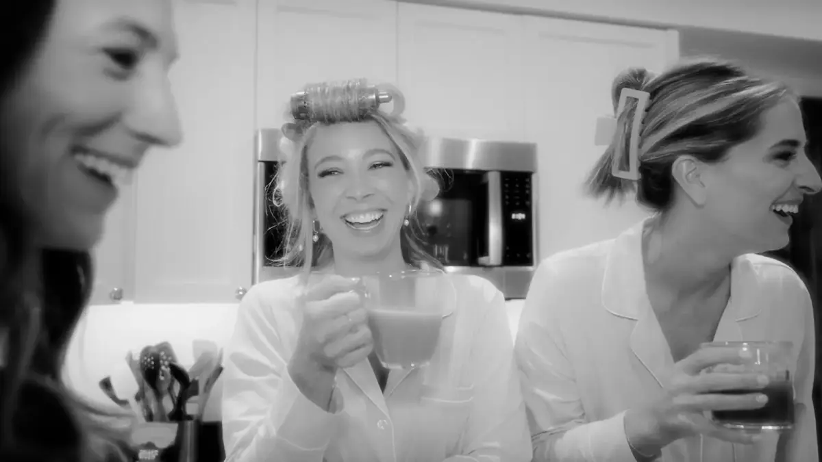 a group of women standing next to each other in a kitchen