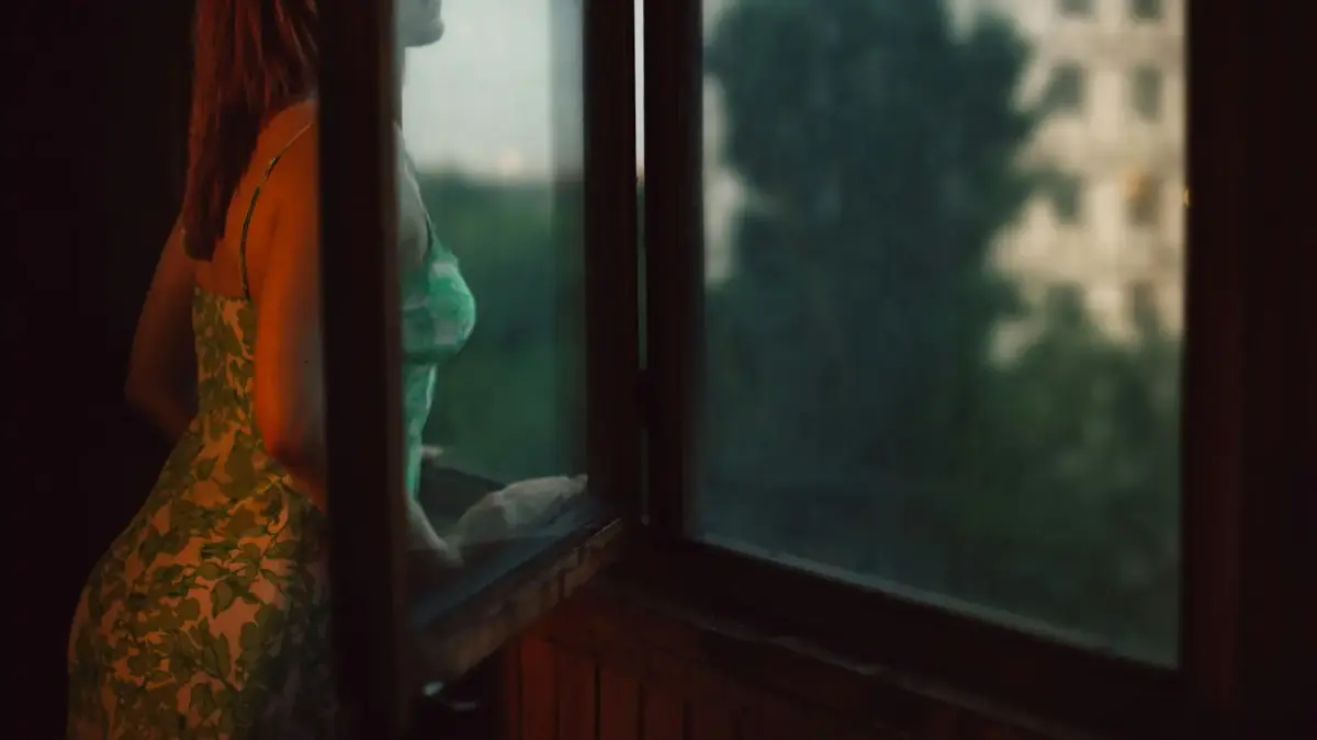 woman leaning on window