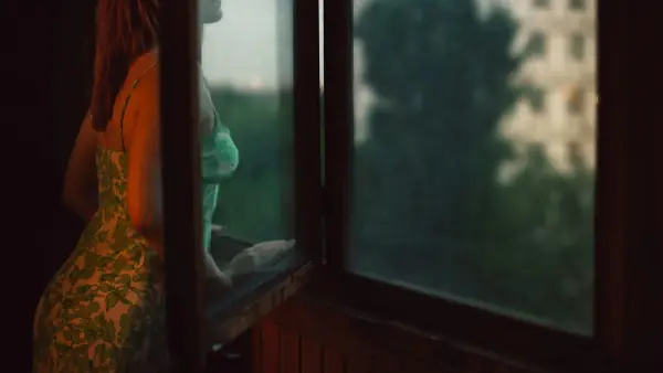 woman leaning on window