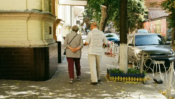 man in white dress shirt and red pants standing near man in white dress shirt