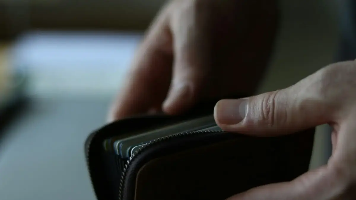 a person holding a wallet in their hand