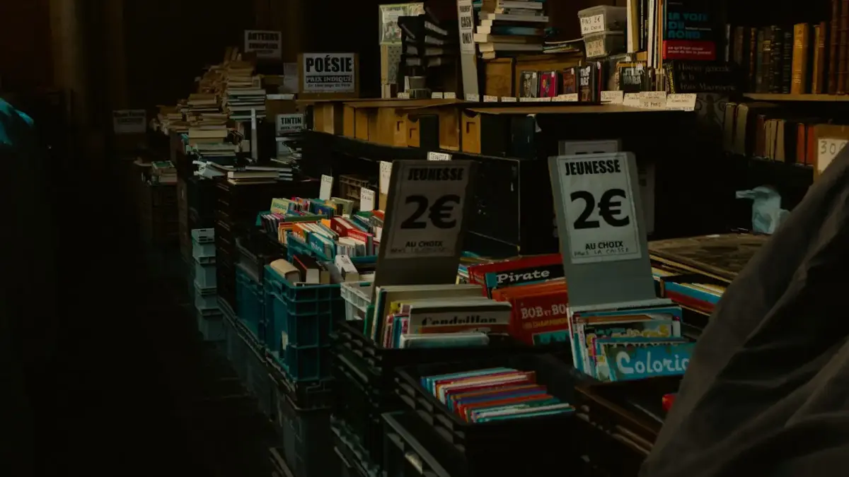 a person standing in a room with shelves of books