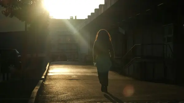 man in black jacket walking on street during daytime