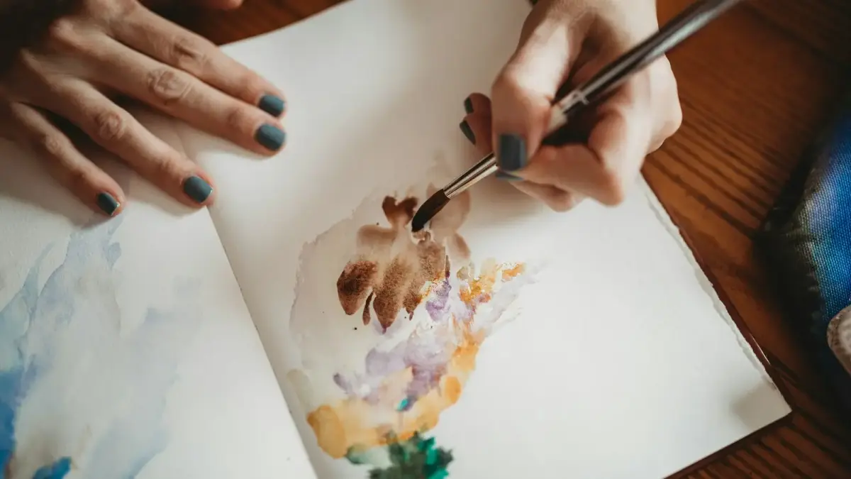 person drawing on white paper