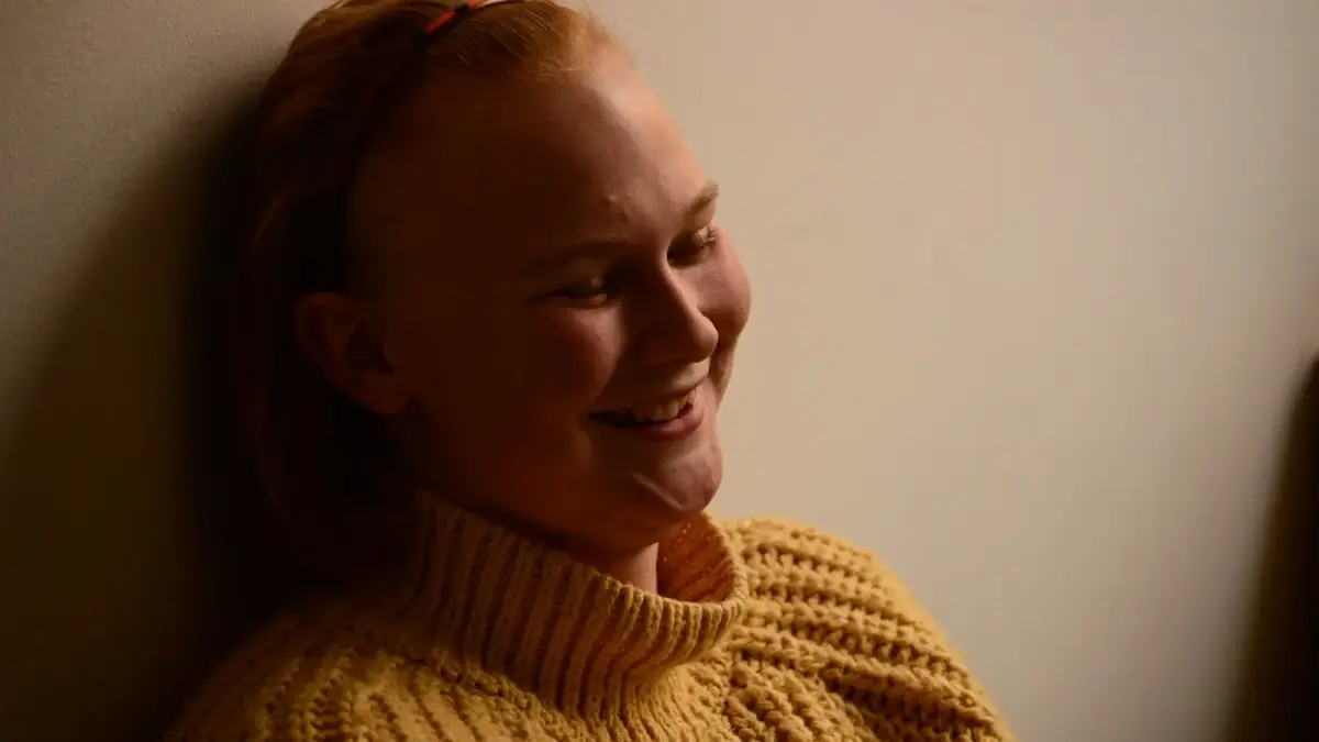 a woman with a ponytail smiling