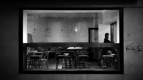 A cafe interior is viewed through the window.