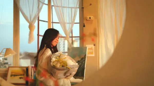 A woman holding a bouquet of flowers in front of a window