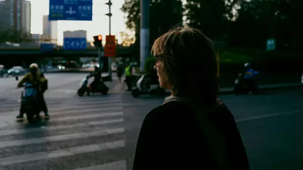 a woman standing in the middle of a street