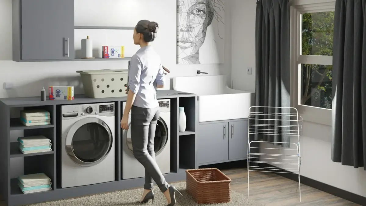 a woman standing in a laundry room next to a washer and dryer