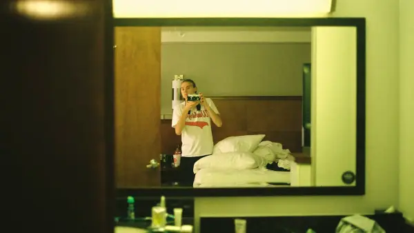 a woman taking a picture of herself in a mirror