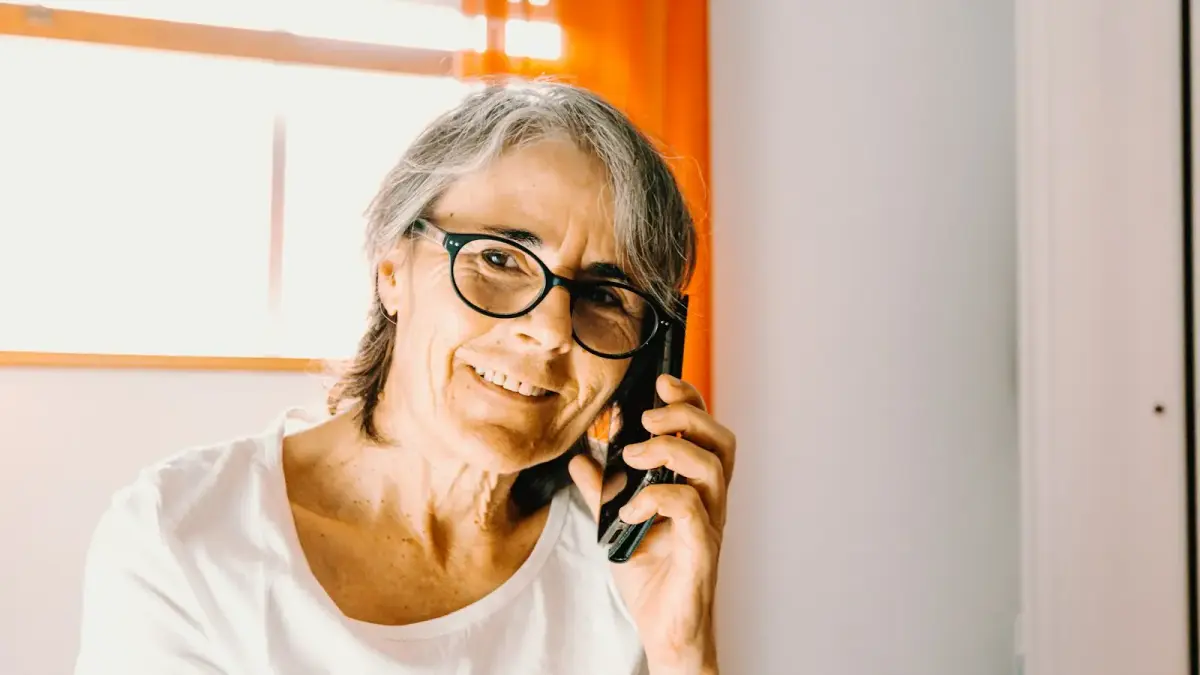 woman in white scoop neck shirt wearing black framed eyeglasses