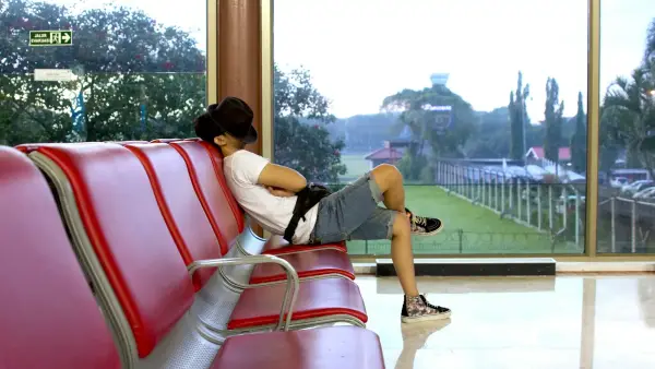 unknown person sitting on red gang chair indoors