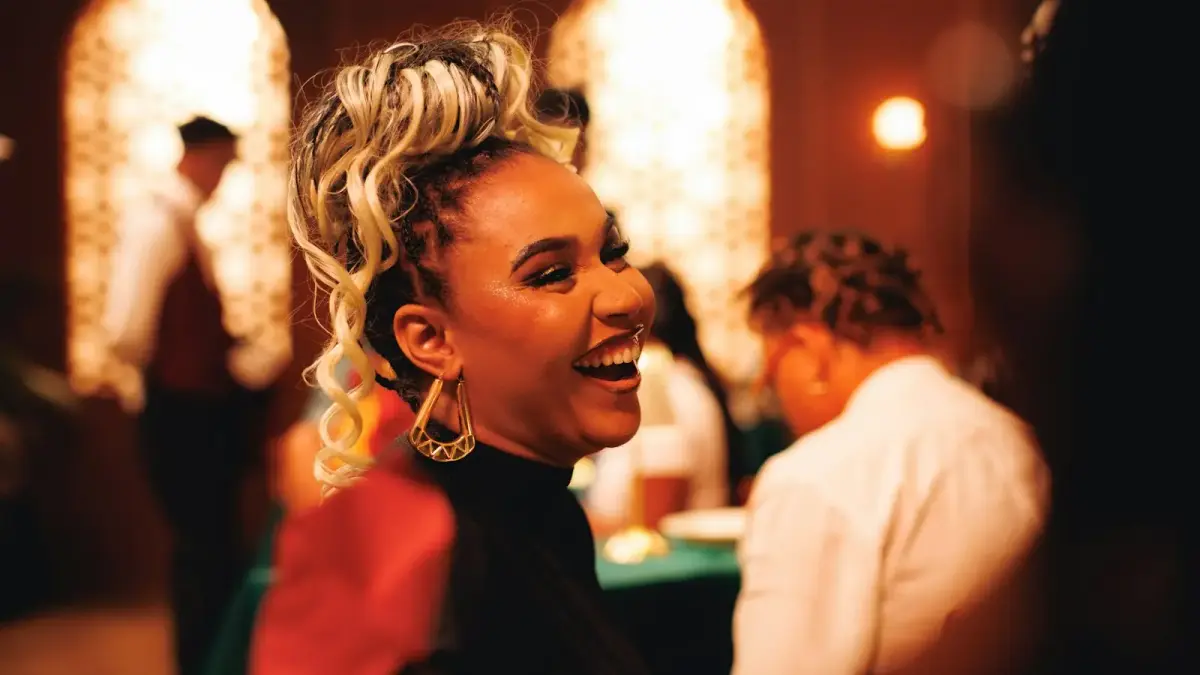 Woman laughs with joy at an event