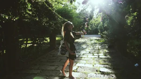 woman wears black elbow-sleeved dress