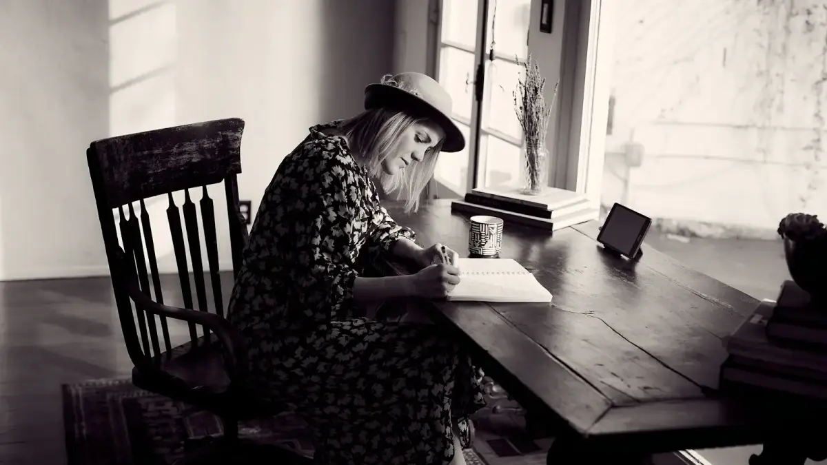 woman in black and white floral dress sitting on chair