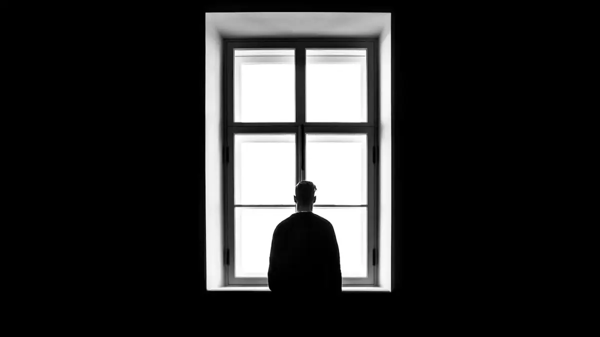 man standing in front of the window