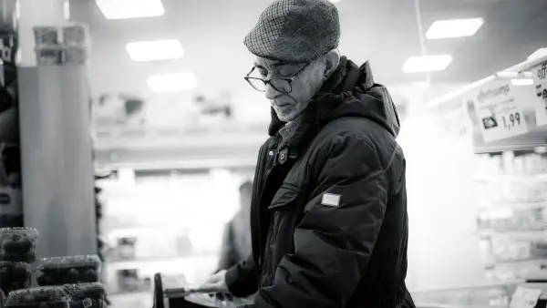 man in black jacket and knit cap