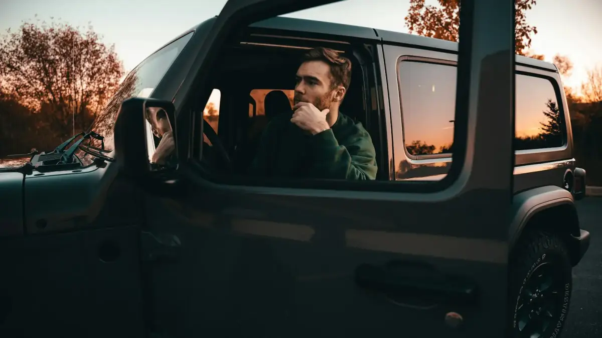 a man sitting in the passenger seat of a car