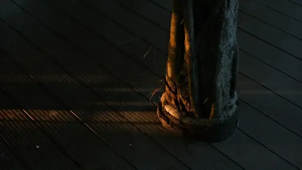 Close-up of a wooden mast on a ship deck